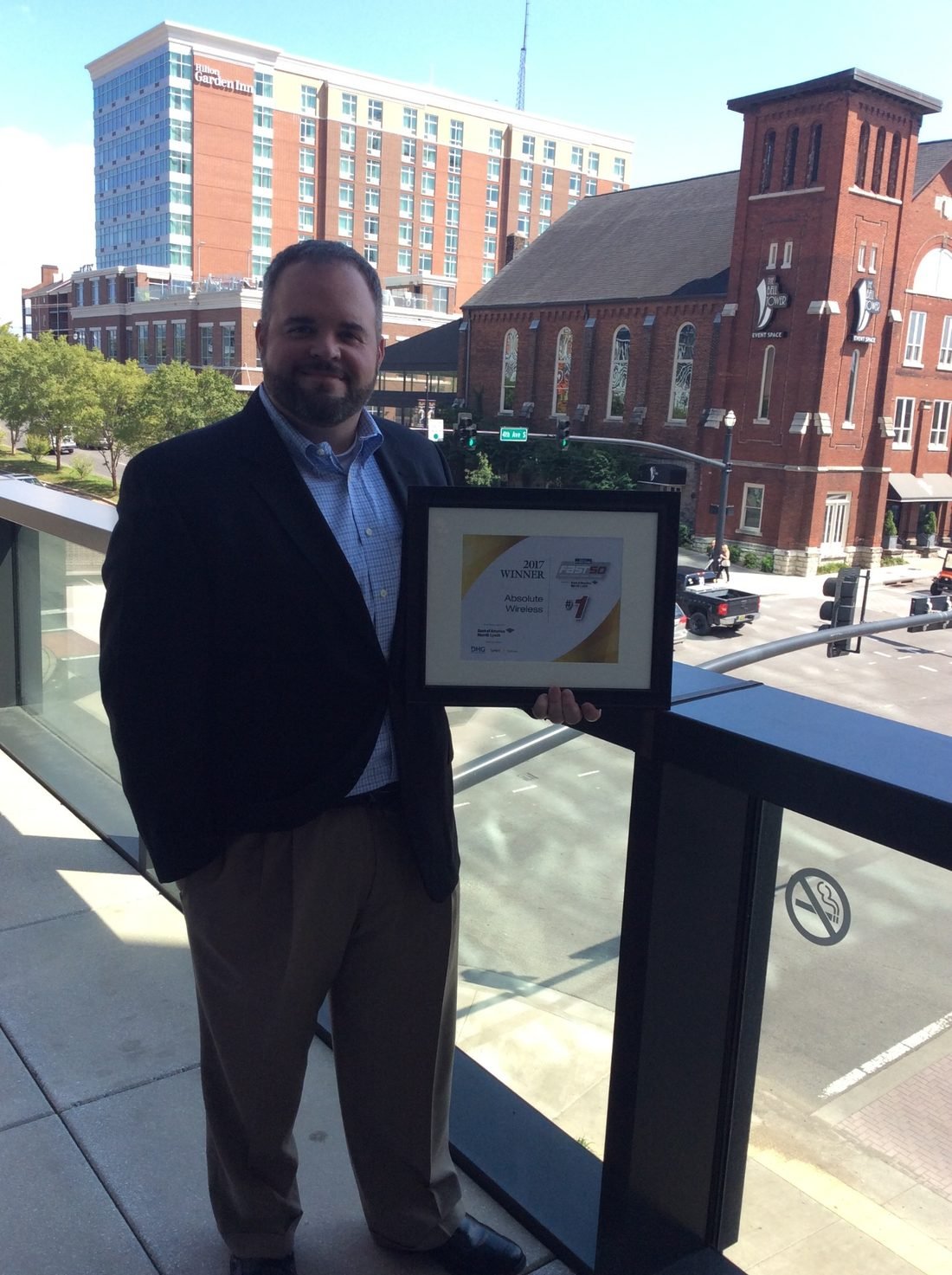 Jim Cripps holding the Fast 50 number one award in downtown Nashville