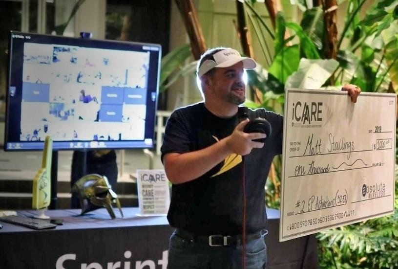 Jim Cripps presenting an iCARE award check to a team member